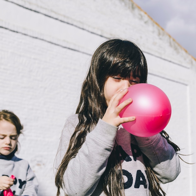 Meisje opblazen van de ballon