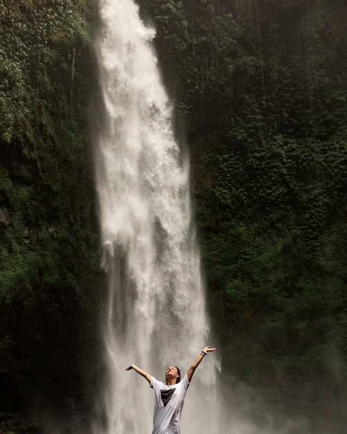 Meisje poseren tegen de achtergrond van een waterval