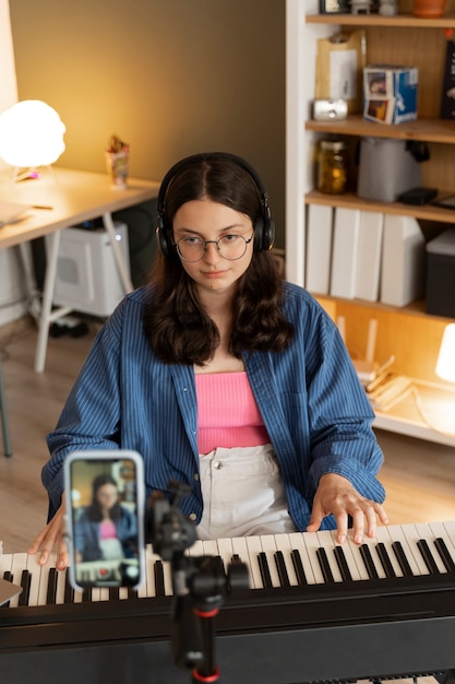 Gratis foto meisje uit een hoge hoek die piano speelt