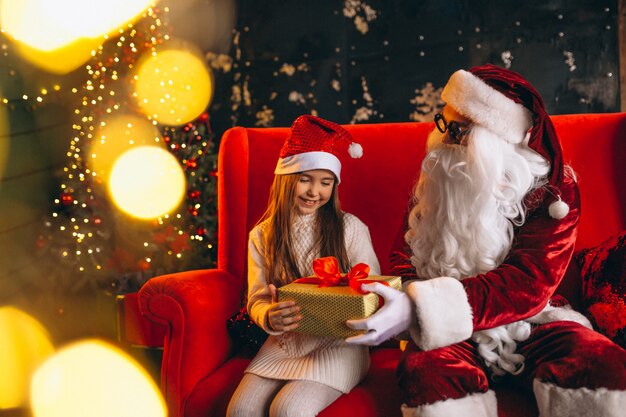 Meisje, zittend met santa en presenteert op Kerstmis