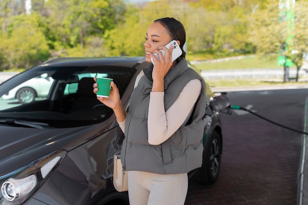 Mening van vrouw met auto bij het benzinestation