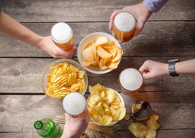 Menselijke handen en glazen bier