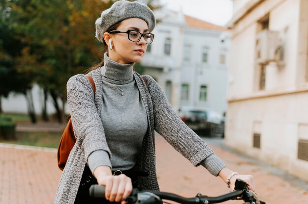 Middelgrote geschoten vrouw die de fiets berijdt