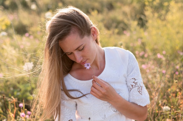 Middelgrote geschoten vrouw met paarse bloem