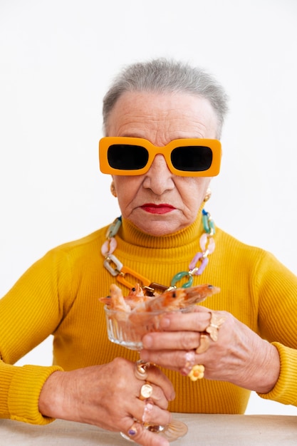 Gratis foto middelgrote senior vrouw poseert in de studio.