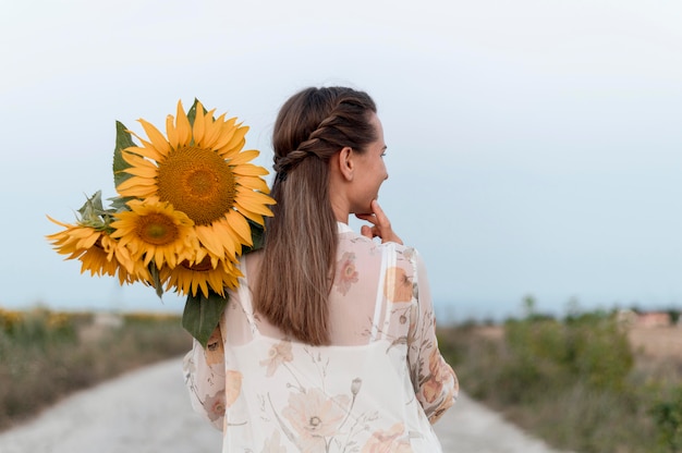 Middellange geschoten vrouw met bloemen