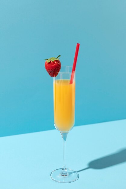 Mimosa glas met aardbei en rood stro