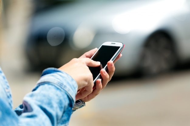 Mobiele telefoon in de hand van een vrouw. Buitenbeeld.