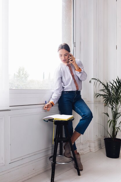 Moderne vrouw die op telefoon spreekt