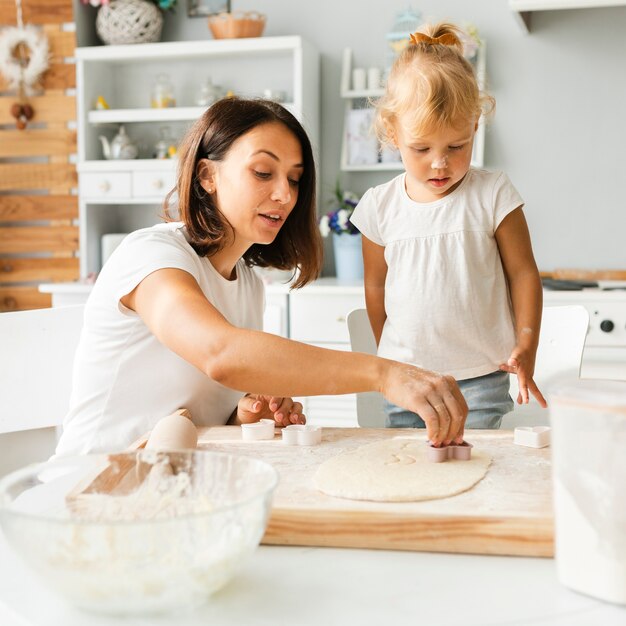 Moeder en dochter die koekjes voorbereiden