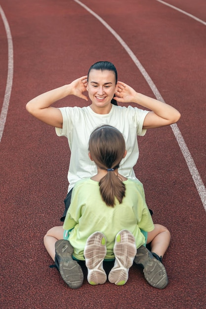 Gratis foto moeder en dochter gaan buiten sporten in het stadion