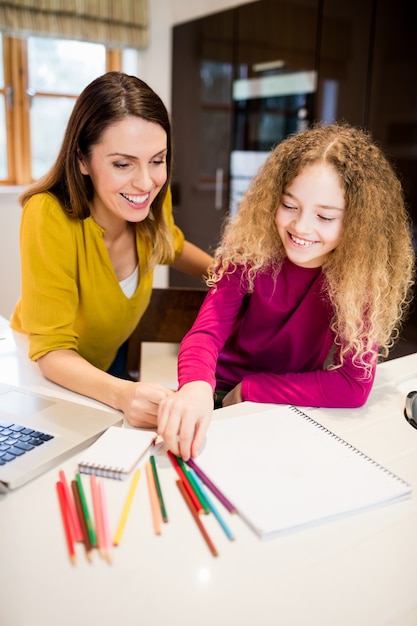 Moeder en dochter helpt dochter met haar huiswerk