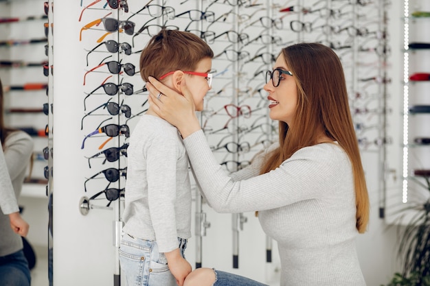Moeder met kleine zoon in de bril winkel
