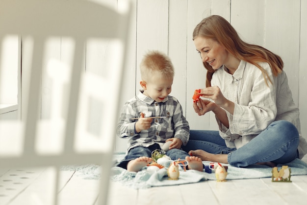 Moeder met zoon die thuis aan pasen voorbereidingen treft