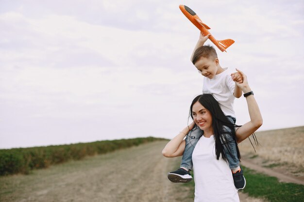Moeder met zoontje spelen met speelgoed vliegtuig