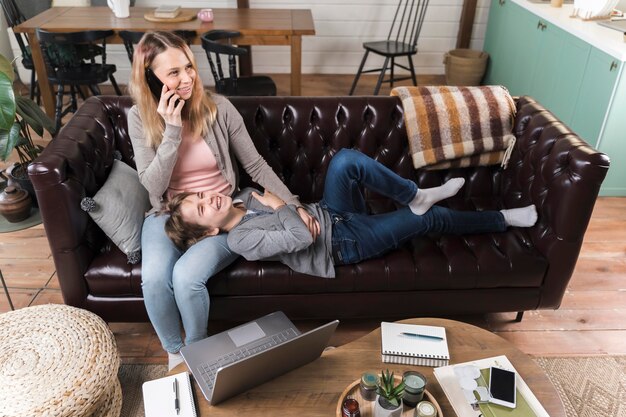 Moeder ontspannen samen met zoon op de bank