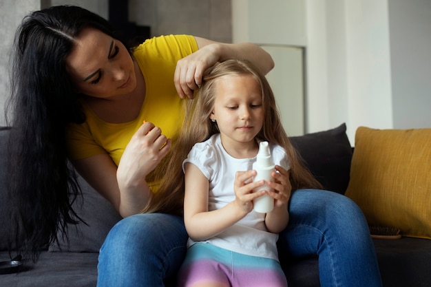 Moeder zorgt voor kind met hoofdluis