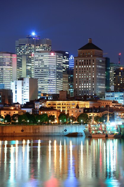 Montreal over rivier in de schemering met stadslichten en stedelijke gebouwen