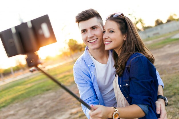 Mooi jong paar dat een selfie in het park neemt.