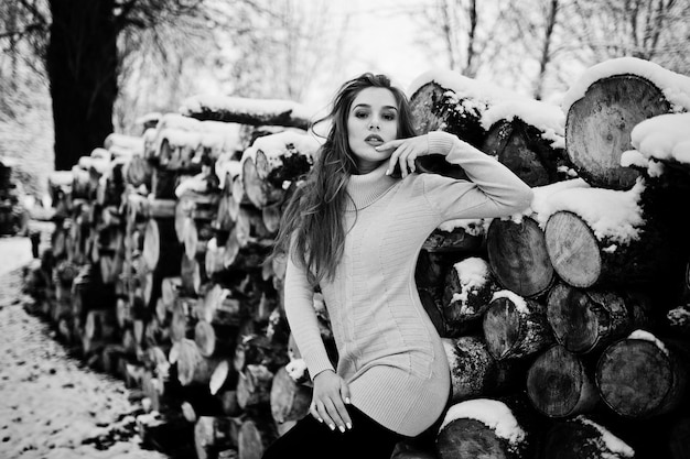 Gratis foto mooie brunette meisje in warme winterkleding model op wintertrui in de buurt van stomp