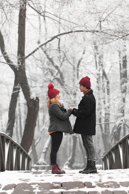 Gratis foto mooie paar hand in hand op een brug