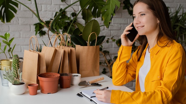 Mooie tuinman praten aan de telefoon