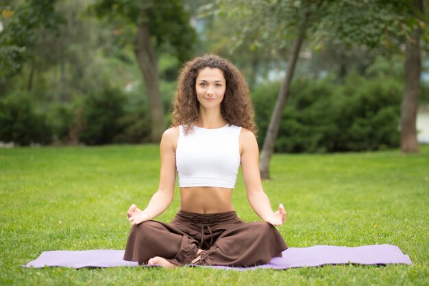 Mooie vrouw die yogaoefeningen doet