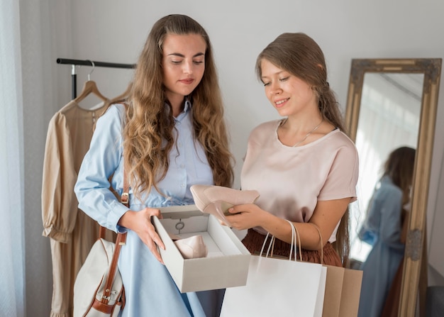 Mooie vrouwen die samen winkelen controleren