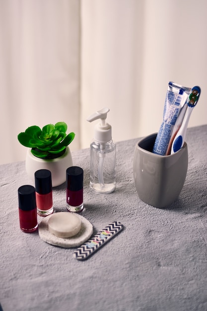 Nagellakken, een zeep, tandenborstel, nagelvijl, spons, een flesje ontsmettingsmiddel en plant