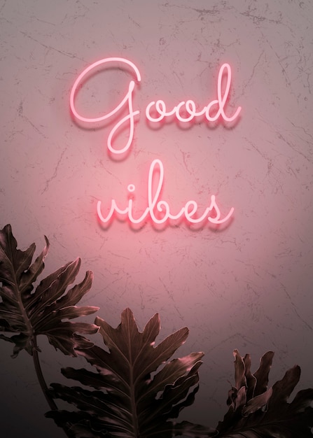 Gratis foto neonrode good vibes op een muur