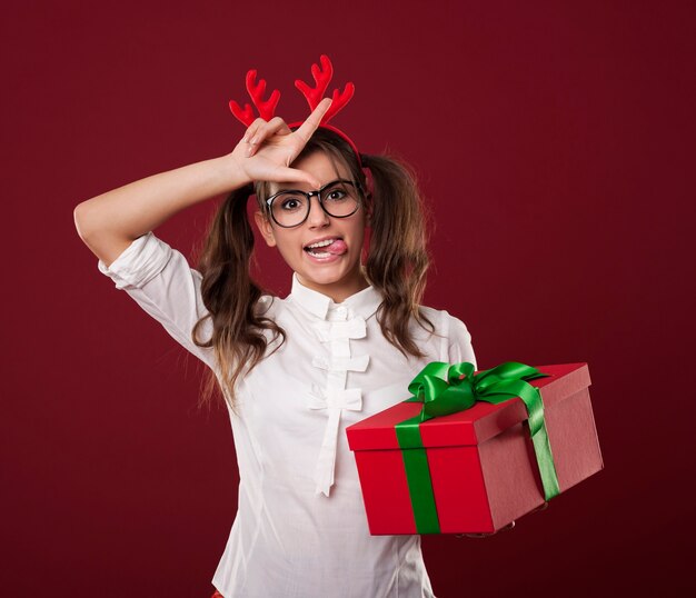 Nerdy vrouw met kerstcadeau verliezer teken tonen