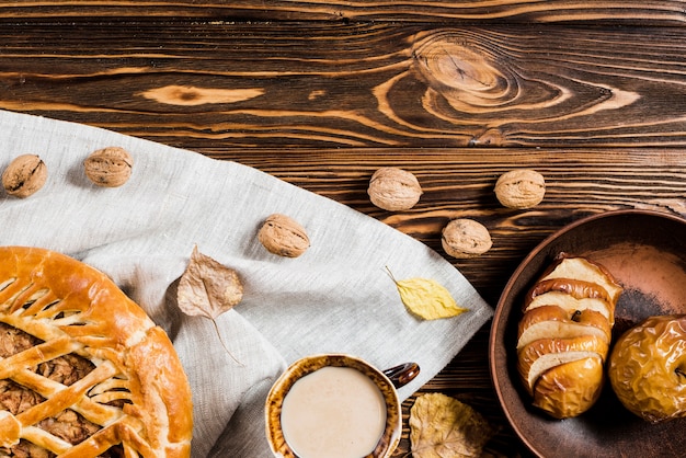 Okkernoten en bladeren dichtbij drank en desserts