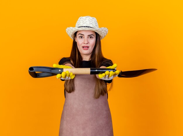 Onder de indruk mooi tuinman meisje uniform dragen en tuinieren hoed