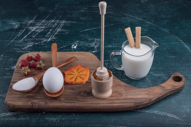 Ontbijtschotel met ingrediënten op een houten bord