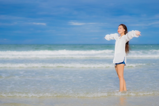 Ontspant de portret mooie jonge aziatische vrouw glimlach rond strand overzeese oceaan in de reisreis van de vakantievakantie