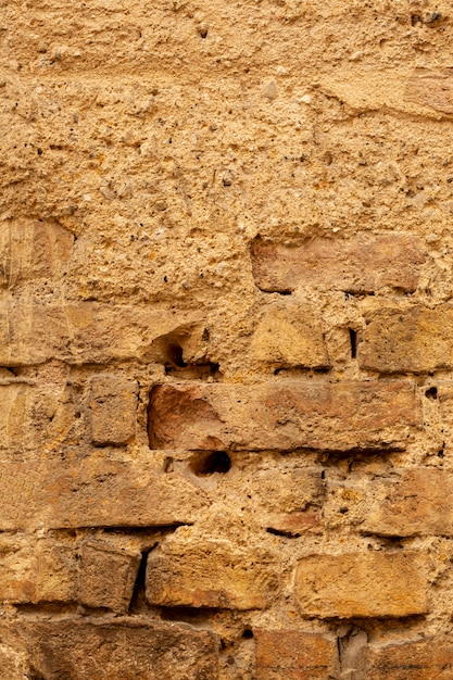 Oude bakstenen muur met cement