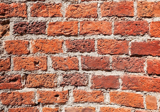 Gratis foto oude bakstenen muur textuur grunge achtergrond donkerrode bakstenen muur uitgehold door de tijd en natuurlijke bakstenen textuur idee voor reclamebanner of productartikel