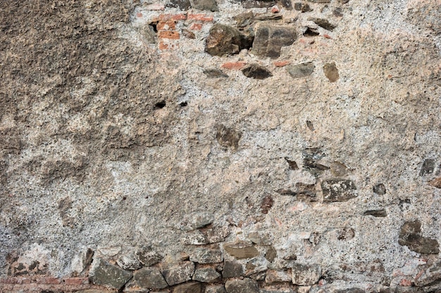 Gratis foto oude getextureerde muur van cement en bakstenen voor achtergrond