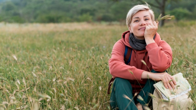 Gratis foto oudere toeristenvrouw in openlucht in aard