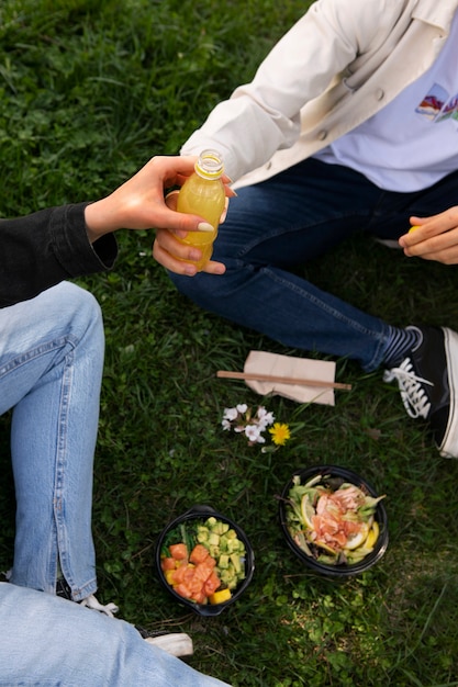 Paar die kom zalm op het gras in openlucht eten