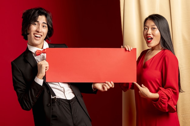 Paar het stellen met rood envelopmodel voor Chinees nieuw jaar