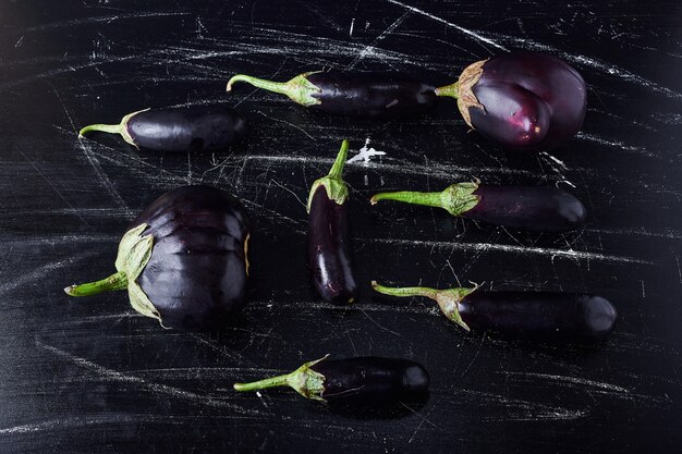 Paarse aubergines op zwart