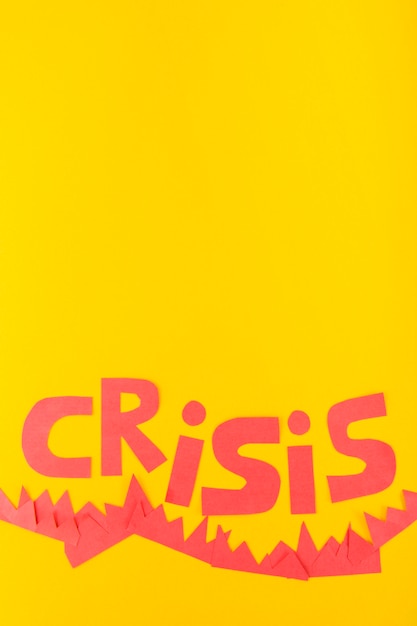 Gratis foto papier crisis belettering op gele achtergrond