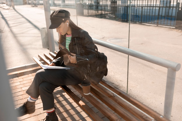 Gratis foto passagier zittend op een hoge mening van een stationsbank