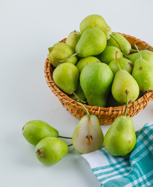 Peren in een mening van de mand hoge hoek over wit en keukenhanddoek