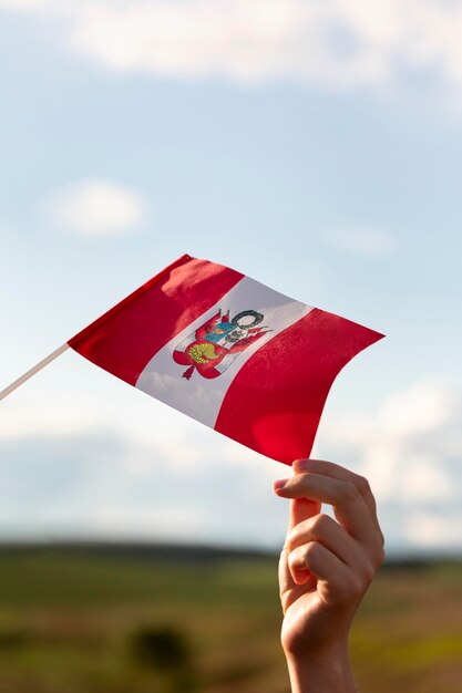 Persoon die de vlag van Peru buiten vasthoudt