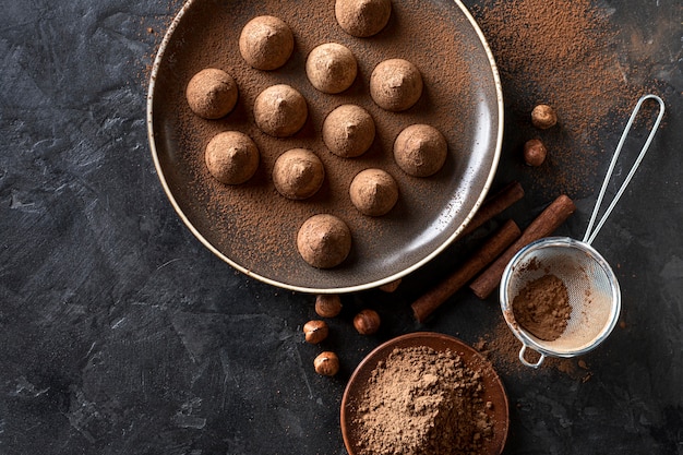 Plat leggen van chocoladesuikergoed met cacaopoeder en kaneelstokjes