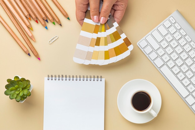 Plat leggen van kleurenpalet voor huisrenovatie met notitieboekje en kleurpotloden