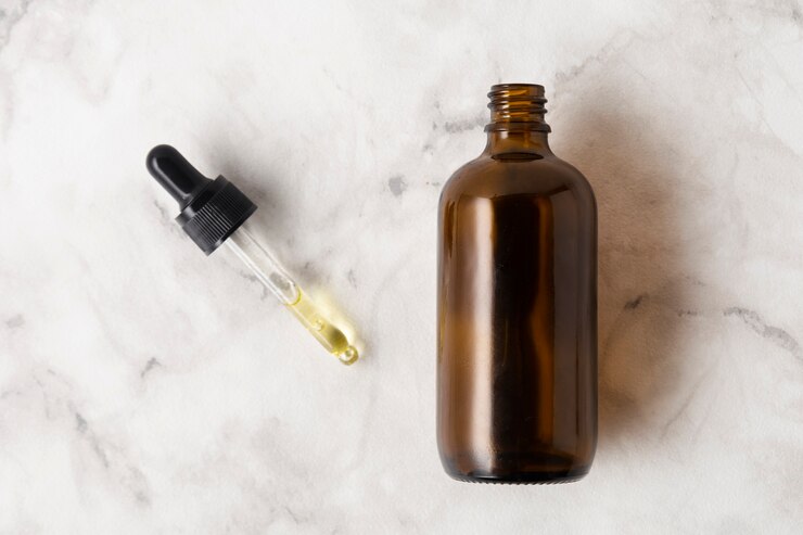 Gratis Foto plat liggende fles voor oliën met pipet