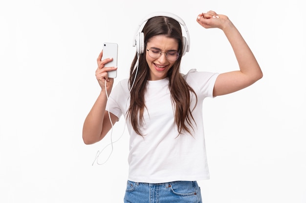 portret expressieve jonge vrouw met mobiele muziek luisteren